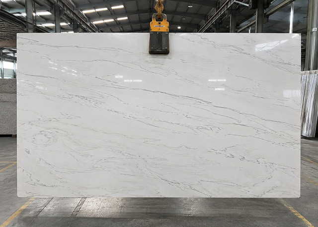 Showroom consultation comparing Calacatta quartzite with cabinet and tile samples