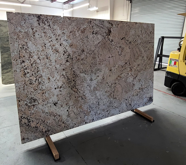 Customer comparing quartzite slabs in a Sacramento countertop showroom